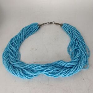 Necklace of many strands of turquoise seed beads‎